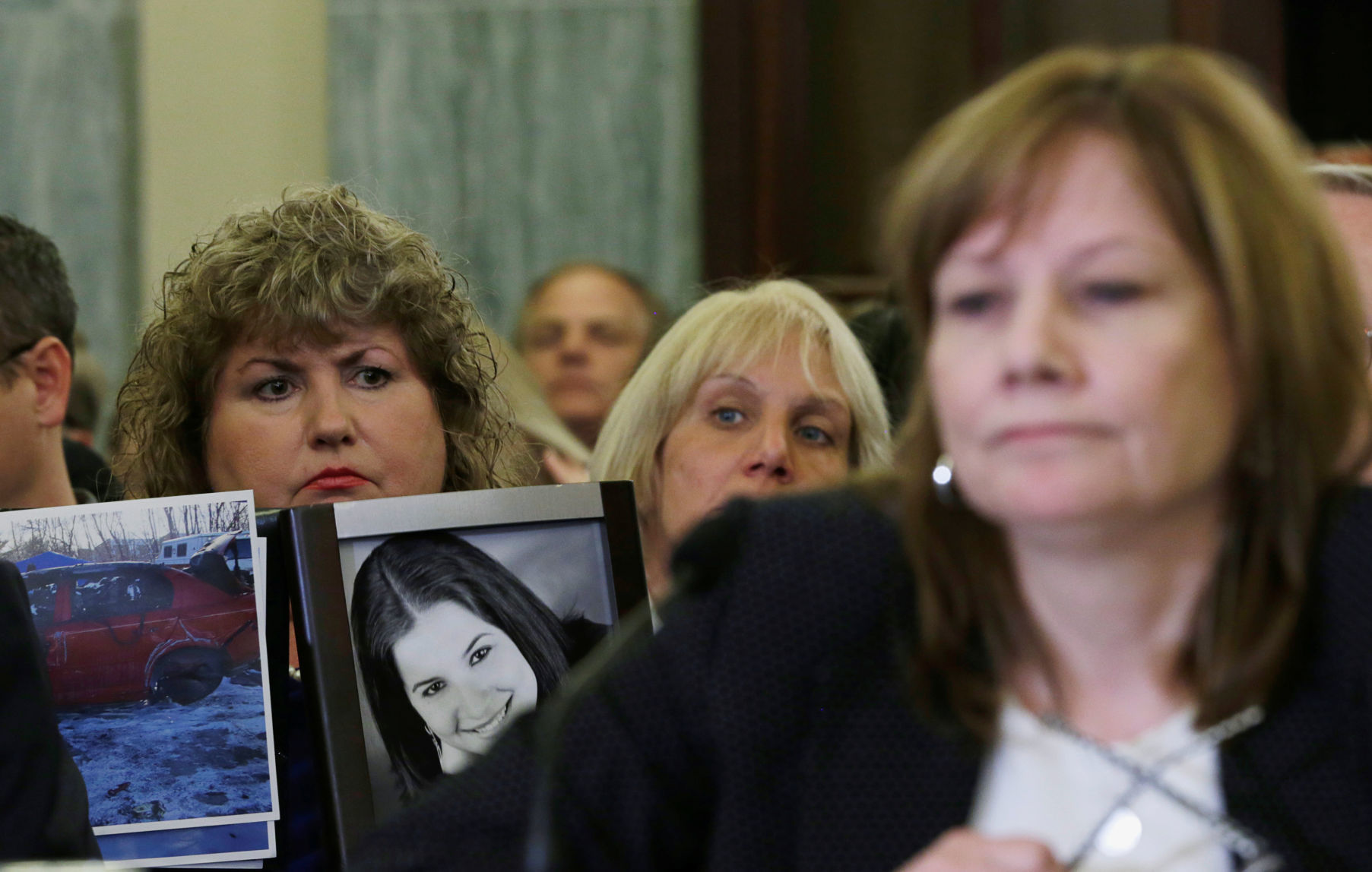 FILE PHOTO: Theresa Ruddy holds pictures as General Motors CEO Barra testifies before Senate Commerce and Transportation Consumer Protection, Product Safety and Insurance subcommittee in Washington